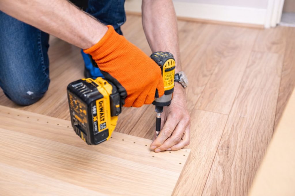 a home improvement pro is assembling a kitchen furniture