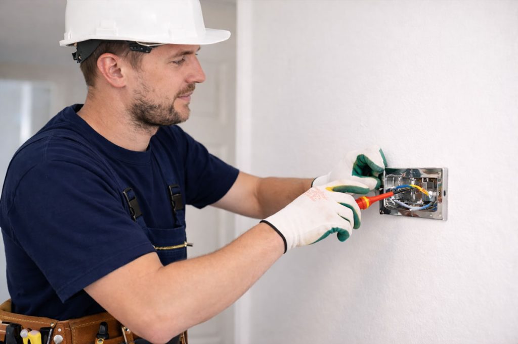 electrician installing a light switch in uk