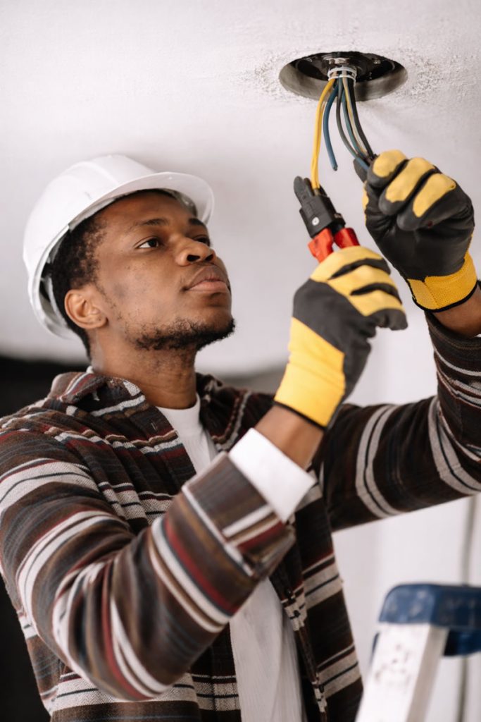 electrician working on light fitting