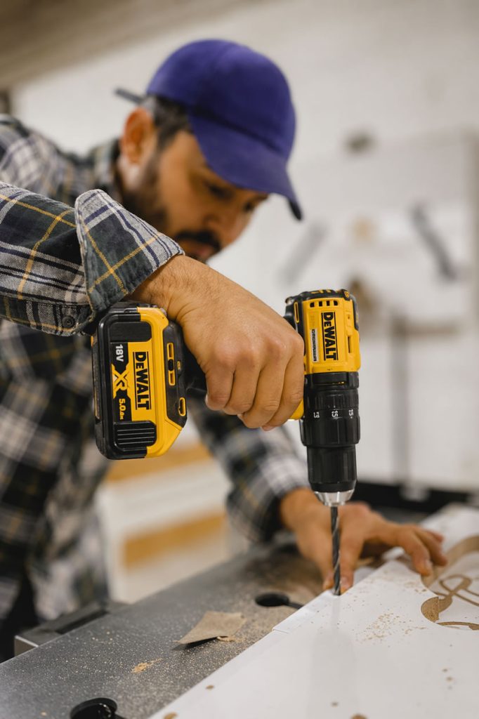 tradesman drilling using a dewalt powertool